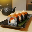Plate of asian sushi roll on the table  with teapot on background