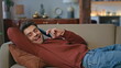 Happy student talking cellphone lying couch close up. Positive man enjoy call