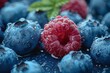 a close up of blueberries and raspberries with water drops on them