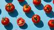 Pomodori rossi interi inquadrati dall'alto su sfondo azzurro