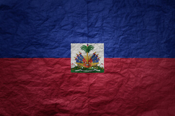 Wall Mural - big national flag of haiti on a grunge old paper texture background