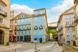 Fototapeta Uliczki - Colorful buildings with shops and cafes in the old town Ribeira district with a tunnel going under the Viewpoint of the Church of São Lourenço, in Porto Portugal.