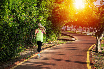 Wall Mural - fitness woman training and jogging in summer park. healthy and sport concept