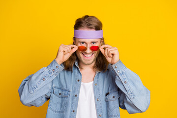 Poster - Portrait of cool young man touch sunglass wear denim shirt isolated on yellow color background