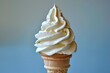 Creamy vanilla ice cream cone against a pastel blue background,