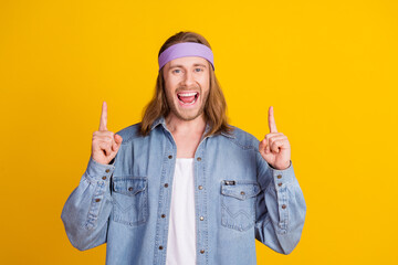 Sticker - Photo portrait of attractive young hippie man point up excited empty space wear trendy denim outfit isolated on yellow color background