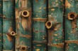 A row of green bamboo sticks with holes in them. The holes are scattered throughout the bamboo, creating a unique and interesting texture. Scene is one of natural beauty and simplicity