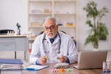 Fototapeta  - Old male doctor pharmacist in drugs synthesis concept