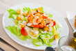 Image of fresh Caesar salad with shrimps on plate at restaurant