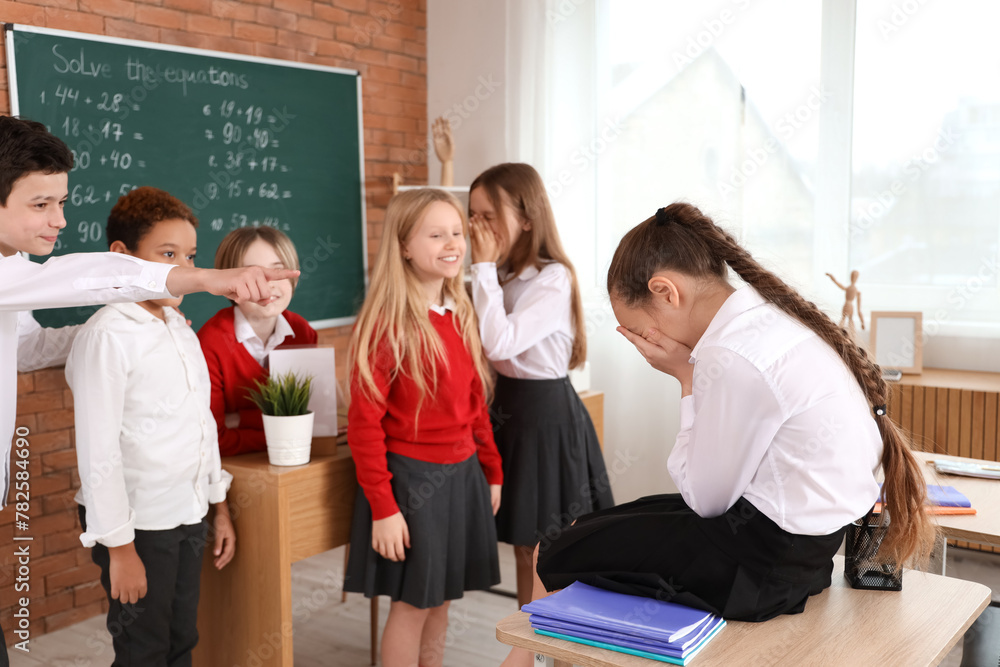 Bullied little girl with her classmates at school