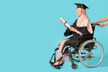 Wall Mural - Beautiful female Muslim graduate student in wheelchair with graduation cap and diploma on blue background