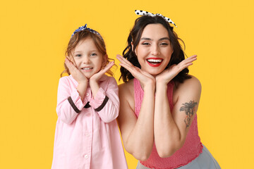 Poster - Happy pin-up woman and her daughter on yellow background