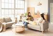 © Pixel-Shot - Young pregnant lesbian couple resting on sofa at home