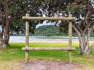 Wall Mural - A Wooden Frame with 'Whangamata' Inscribed, Welcoming Visitors to the Beach Road Reserve