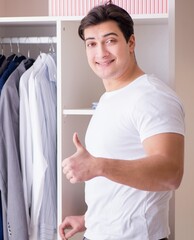 Wall Mural - Young man businessman getting dressed for work