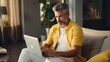 © Rose on Lens - Relaxed man in a vibrant yellow shirt, exuding warmth and confidence in a sunlit bedroom