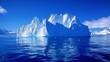 A large, imposing iceberg with symmetrical formations is seen floating in the middle of the ocean. The iceberg stands out against the vast expanse of water surrounding it.