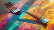 Shiny metal fork lies on surface with vivid, colorful reflections creating abstract and artistic effect