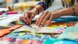 A closeup shot captures a designers hands delicately arranging different swatches of fabrics and papers constructing a colorful and textured collage. The carefully selected pieces .