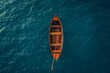 Aerial view of a solitary wooden boat on calm turquoise waters