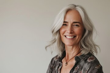 Portrait of a beautiful senior woman with white hair smiling at the camera