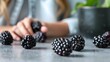 A close up of several delicious, juicy blackberries that are lying on a gray table. selective attention. Concept of vitamins in fresh fruit.
