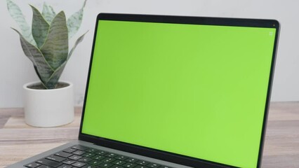 Closeup of green screen laptop for website mockup. Panning shot of computer with chroma key in 4K.