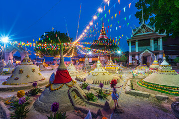 Wall Mural - PHITSANULOK, THAILAND - April 11,2024:Thai people come to build the sand Pagoda for return the sand to the temple on Songkran festival Thai tradition at Ratchaburana temple in Phitsanulok,Thailand.