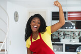 Fototapeta  - Portrait of  motivated african american au pair with apron at kitchen