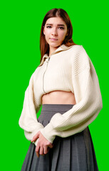 Wall Mural - Young Woman in Casual White Zip-Up and Grey Skirt Posing Against Green Background