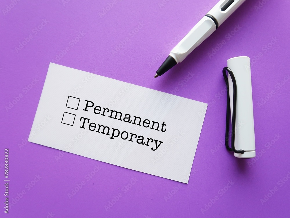 Paper note on purple background with pen ticking on choices PERMANENT ...