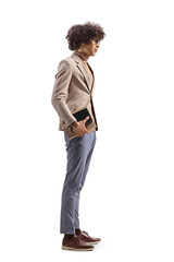 Sticker - Full length profile shot of a young slim man holding a book