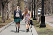 Two young women walking in a park, female fashion in spring city