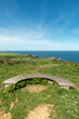 Wooden bench standing on the high ocean cliff near Luanco, Asturias,Spain