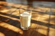 A realistic 3D rendering of a glass of milk placed on a wooden table