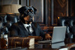 A dog is sitting at a desk with a laptop in front of him. He is wearing a suit and tie, giving the impression that he is a professional