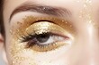 Model wearing gold eyeshadow sparkling eyes