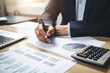 © evening_tao - Professional Analyzing Financial Data at His Desk