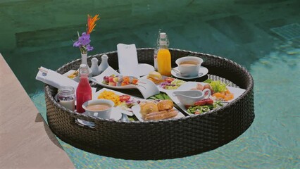 Wall Mural - Luxurious floating breakfast served in private swimming pool at exotic resort. Tropical vacation dining experience with fresh fruit, beverages, and full meal. Upscale travel and leisure.