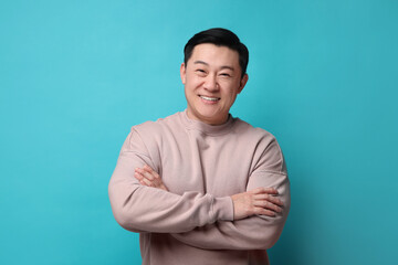 Poster - Portrait of happy man on light blue background