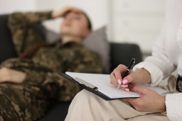 Canvas Print - Psychotherapist working with military woman in office, closeup