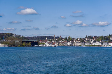 Wall Mural - Scenic view of Lake Lucern with the old town of Swiss City of Lucerne in the background on a sunny spring day. Photo taken April 11th, 2024, Lucerne, Switzerland.