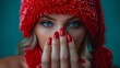 The nails of a woman with extensions of red color nails on the Christmas celebration. This is a close-up of the nails covered with small red hats of Santa. Last chapter of the year banner. Beautiful