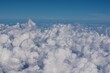 Vast cloudscape with whte, fluffy clouds seen from above
