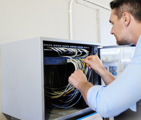 Wall Mural - Server room, man or technician fixing cables for cyber security glitch, web 3.0 or hardware cords. Engineering, programmer or engineer with wires for information technology, machine or IT support