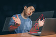 Man using laptop with triangle caution warning sign for notification error..