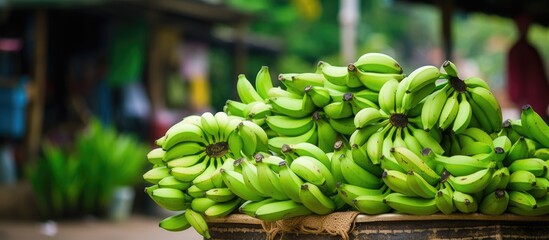 Fototapete - Bunches of bananas in basket on table