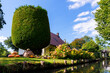 Scenic view of green riverside garden house german national park Spreewald on spring summer sunny day . Spree river forest greenery canal nature tranquil landscape in Germany blue sky background