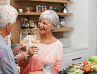 Wall Mural - Old couple, toast and happiness in kitchen with wine for retirement, celebration and cooking in apartment. Senior woman, and vacation for love, commitment and wellness in modern house for holiday.