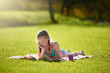© peopleimages.com - Girl, book or reading to relax, grass or imagine by story, freedom or vacation at summer camp. Tween, novel or fiction as thinking to wonder of idea, dream or fantasy by lying on ground in nature